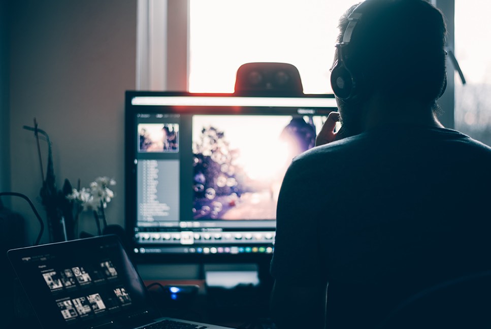 An editor working at a video editing workstation